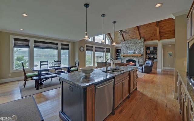 2156 Mockingbird Ln, Hiawassee, GA 30546 - kitchen featuring stainless steel dishwasher, a sink, a fireplace, light wood-style floors, and lofted ceiling