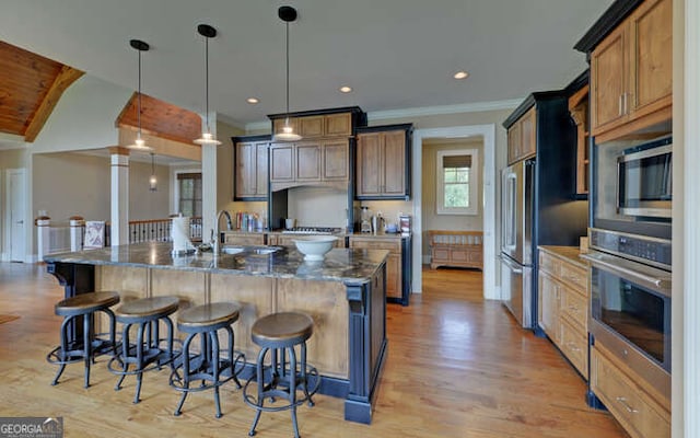 2156 Mockingbird Ln, Hiawassee, GA 30546 - kitchen featuring stainless steel appliances, a kitchen bar, a sink, a spacious island, and hanging light fixtures
