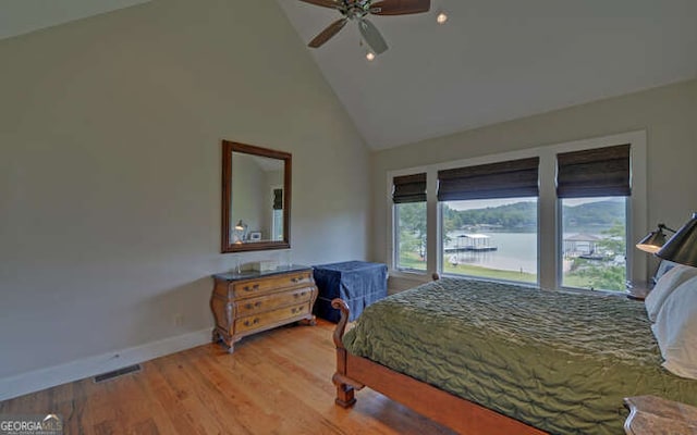 2156 Mockingbird Ln, Hiawassee, GA 30546 - bedroom featuring high vaulted ceiling, baseboards, light wood-style floors, ceiling fan, and a water view