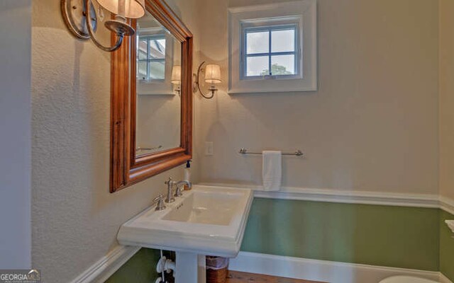 2156 Mockingbird Ln, Hiawassee, GA 30546 - half bathroom with healthy amount of natural light, toilet, and baseboards