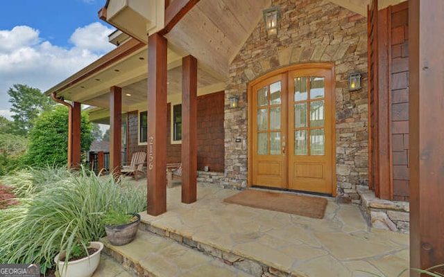 2156 Mockingbird Ln, Hiawassee, GA 30546 - view of exterior entry with stone siding and covered porch