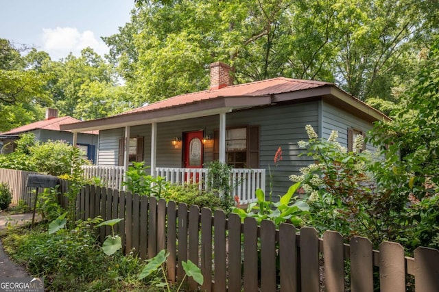 140 Lakeview St, Athens, GA 30601 - view of front of house featuring covered porch, a metal roof, and a chimney