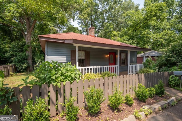 140 Lakeview St, Athens, GA 30601 - view of front of house with a porch, a metal roof, and a chimney