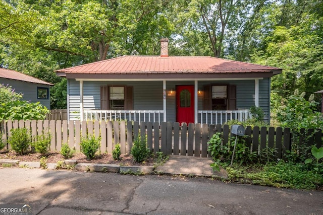 140 Lakeview St, Athens, GA 30601 - bungalow-style home with covered porch, a fenced front yard, a metal roof, and a chimney