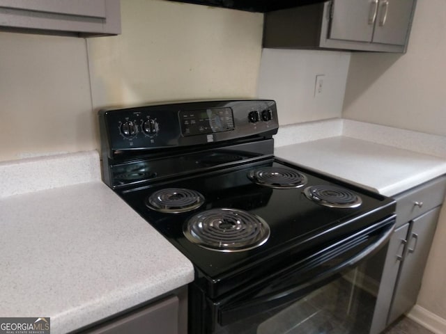 2566 Stratford Ln, Morrow, GA 30260 - kitchen with black range with electric stovetop, light countertops, and gray cabinetry