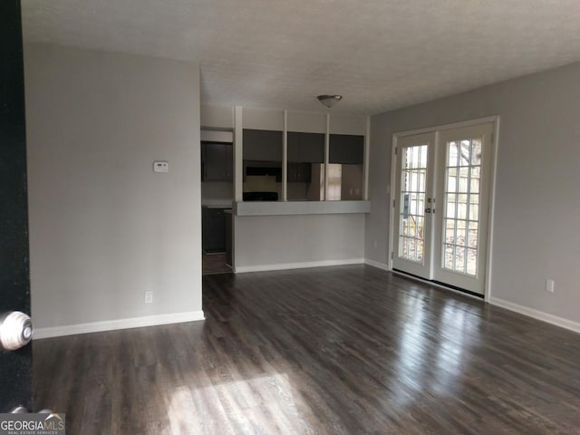 2566 Stratford Ln, Morrow, GA 30260 - unfurnished living room featuring baseboards, dark wood finished floors, and french doors