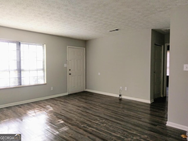 2566 Stratford Ln, Morrow, GA 30260 - spare room featuring dark wood-type flooring, baseboards, and a textured ceiling