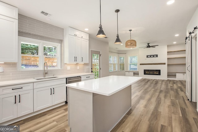 300 Windsor Chase Trl, Johns Creek, GA 30097 - kitchen featuring a sink, recessed lighting, light wood-style flooring, a barn door, and light countertops