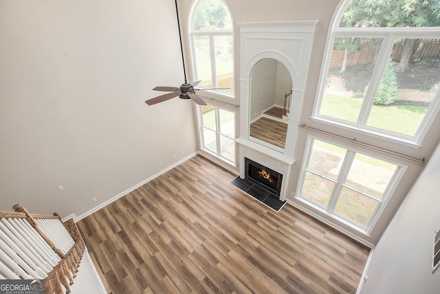300 Windsor Chase Trl, Johns Creek, GA 30097 - unfurnished living room featuring light wood-style flooring, baseboards, healthy amount of natural light, and a fireplace with flush hearth