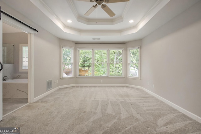 300 Windsor Chase Trl, Johns Creek, GA 30097 - carpeted spare room featuring ornamental molding, a barn door, a ceiling fan, baseboards, and a raised ceiling