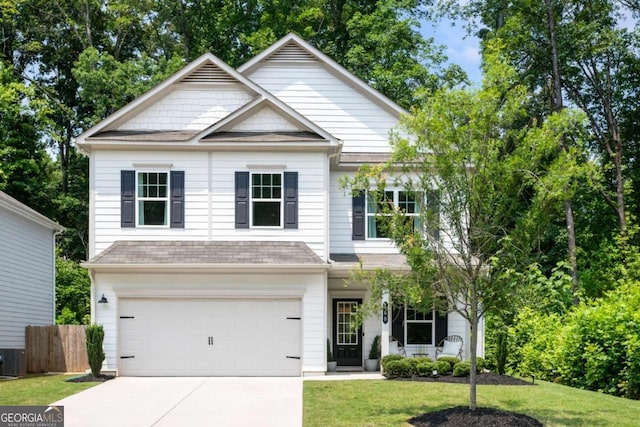 160 Winner St, Acworth, GA 30102 - view of front of house featuring concrete driveway, a garage, covered porch, roof with shingles, and central air condition unit