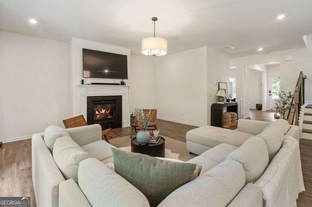 160 Winner St, Acworth, GA 30102 - living room featuring wood finished floors, a glass covered fireplace, baseboards, recessed lighting, and stairway