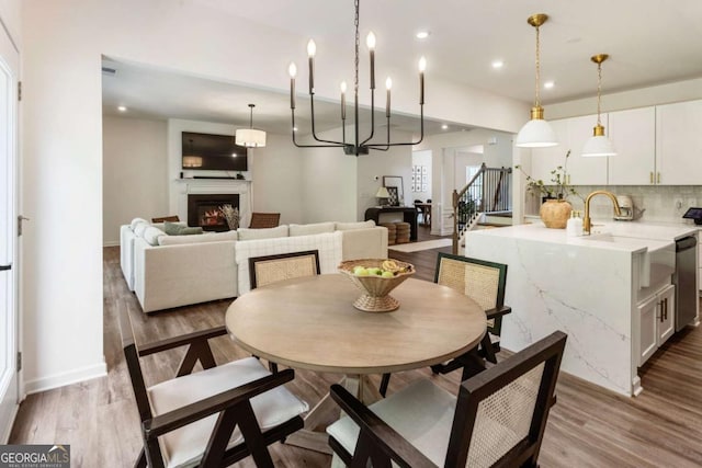 160 Winner St, Acworth, GA 30102 - dining area with a lit fireplace, wood finished floors, recessed lighting, and baseboards