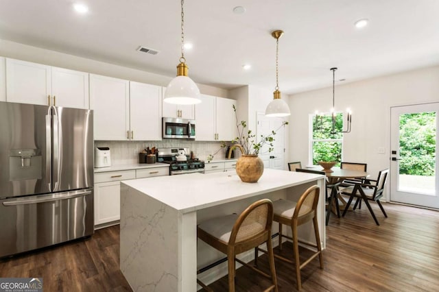 160 Winner St, Acworth, GA 30102 - kitchen featuring appliances with stainless steel finishes, dark wood-type flooring, decorative backsplash, white cabinetry, and recessed lighting