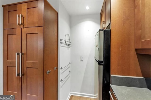 57 Cantey Pl NW, Atlanta, GA 30327 - kitchen with freestanding refrigerator, brown cabinets, and recessed lighting