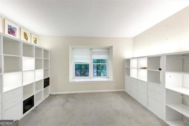 57 Cantey Pl NW, Atlanta, GA 30327 - unfurnished living room featuring baseboards and concrete floors
