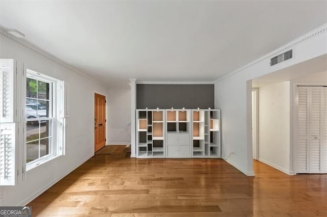 57 Cantey Pl NW, Atlanta, GA 30327 - unfurnished living room with wood finished floors and crown molding