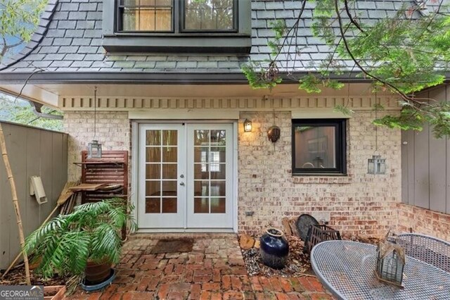 57 Cantey Pl NW, Atlanta, GA 30327 - doorway to property featuring french doors, a patio area, and brick siding