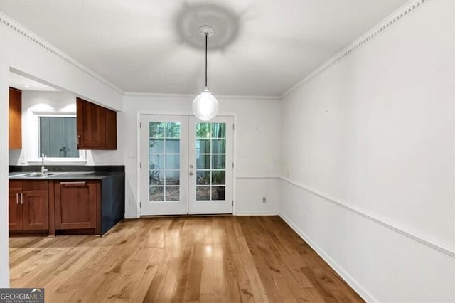 57 Cantey Pl NW, Atlanta, GA 30327 - unfurnished dining area with french doors, light wood-type flooring, and ornamental molding