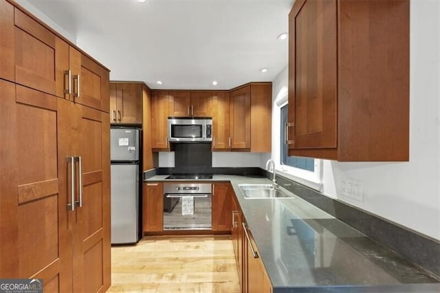 57 Cantey Pl NW, Atlanta, GA 30327 - kitchen featuring stainless steel appliances, brown cabinetry, light wood-type flooring, and recessed lighting