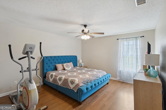 903 Teepee Way, Statesboro, GA 30461 - bedroom with wood finished floors, a textured ceiling, baseboards, and ceiling fan