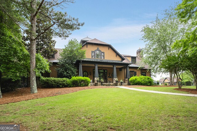 1604 Falcon Ct, Locust Grove, GA 30248 - craftsman house featuring a front yard, a porch, and a chimney