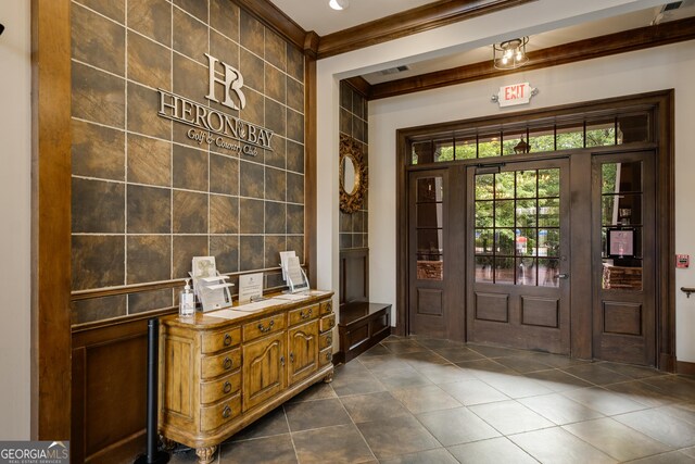 1604 Falcon Ct, Locust Grove, GA 30248 - foyer featuring crown molding, dark tile patterned flooring, and tile walls