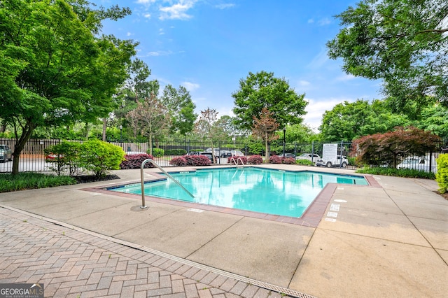 425 Chapel St SW Unit 1107, Atlanta, GA 30313 - community pool featuring a patio area and view of wooded area