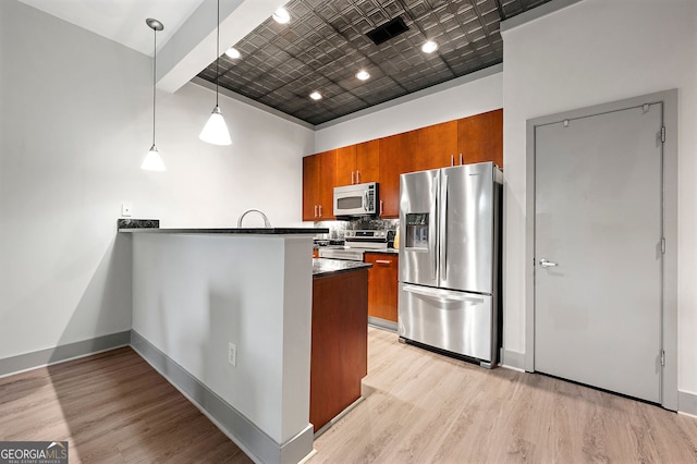 425 Chapel St SW Unit 1107, Atlanta, GA 30313 - kitchen with stainless steel appliances, brown cabinetry, and light wood finished floors