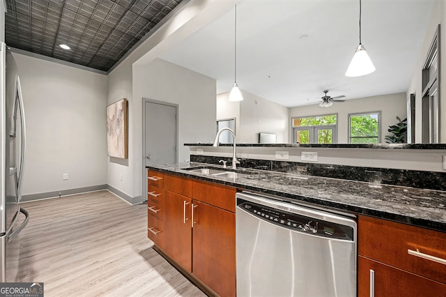 425 Chapel St SW Unit 1107, Atlanta, GA 30313 - kitchen with appliances with stainless steel finishes, light wood-type flooring, brown cabinetry, and decorative light fixtures