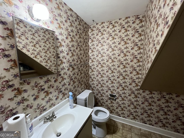 2972 Clairmont Ave, Macon, GA 31204 - half bath featuring baseboards, toilet, vanity, and wallpapered walls