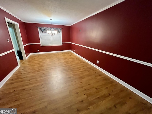 2972 Clairmont Ave, Macon, GA 31204 - unfurnished dining area featuring a chandelier, wood finished floors, ornamental molding, and baseboards