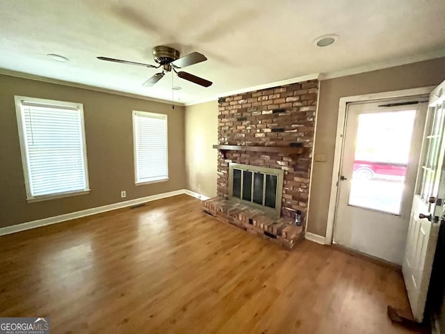2972 Clairmont Ave, Macon, GA 31204 - unfurnished living room featuring wood finished floors, crown molding, a brick fireplace, a ceiling fan, and baseboards