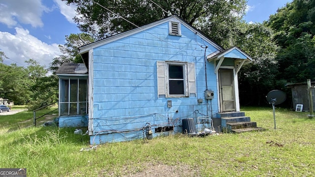 609 Virginia Cir, Montezuma, GA 31063 - back of house with entry steps, a yard, and a sunroom