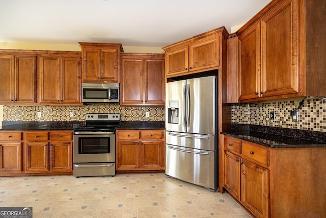 104 Hamilton Lake View Ct, Lagrange, GA 30241 - kitchen featuring appliances with stainless steel finishes, brown cabinets, and dark stone counters