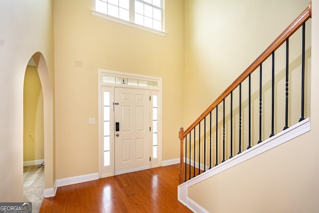 104 Hamilton Lake View Ct, Lagrange, GA 30241 - foyer entrance with a high ceiling, wood finished floors, baseboards, stairs, and arched walkways