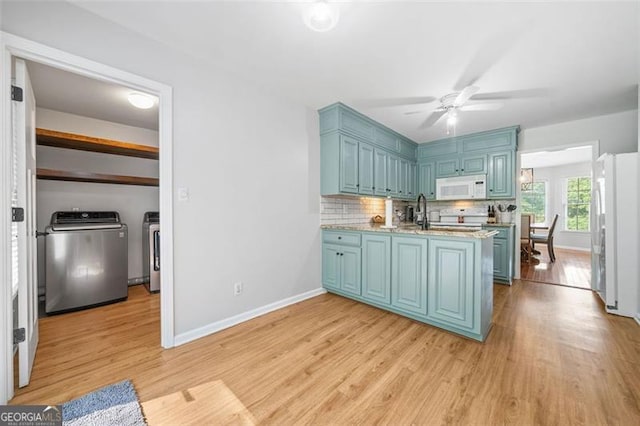 4458 Trickum Rd, Marietta, GA 30066 - kitchen with white appliances, blue cabinets, and tasteful backsplash