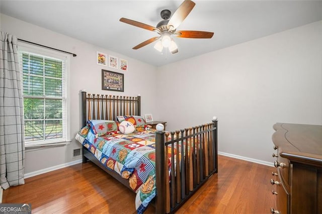 4458 Trickum Rd, Marietta, GA 30066 - bedroom with baseboards, wood finished floors, and a ceiling fan