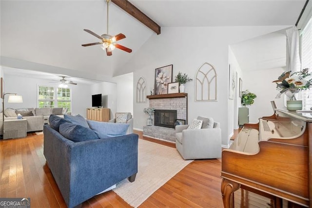 4458 Trickum Rd, Marietta, GA 30066 - living room featuring a ceiling fan, beam ceiling, wood finished floors, a fireplace, and high vaulted ceiling