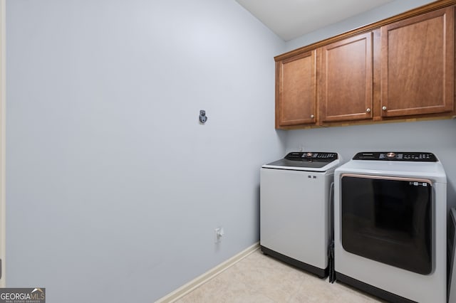 2245 Long Bow Chase, Kennesaw, GA 30144 - laundry area with cabinet space, washing machine and dryer, baseboards, and light tile patterned flooring