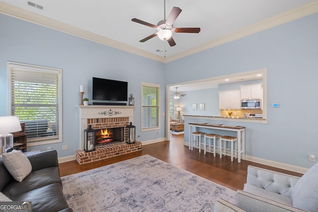 2245 Long Bow Chase, Kennesaw, GA 30144 - living room featuring ceiling fan, ornamental molding, plenty of natural light, a fireplace, and dark wood-style floors