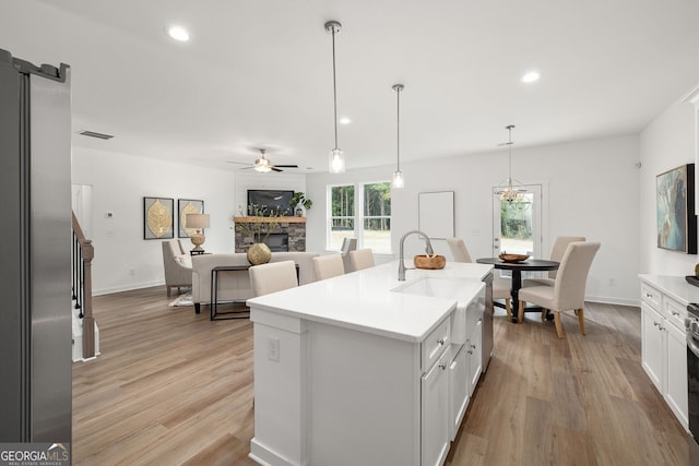 247 Annie Ln, Statham, GA 30666 - kitchen with a fireplace, light wood-style flooring, light countertops, and recessed lighting