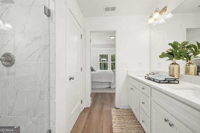 247 Annie Ln, Statham, GA 30666 - ensuite bathroom featuring double vanity, wood finished floors, and a tile shower