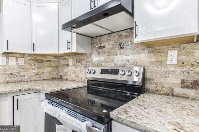 1017 Oak Ridge Dr, Byron, GA 31008 - kitchen with electric range, under cabinet range hood, tasteful backsplash, and white cabinets