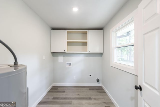 1017 Oak Ridge Dr, Byron, GA 31008 - laundry room with cabinet space, light wood-style flooring, hookup for a washing machine, baseboards, and hookup for an electric dryer