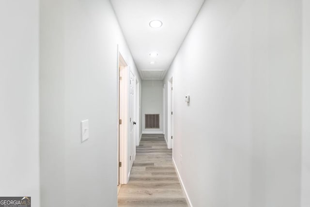 1017 Oak Ridge Dr, Byron, GA 31008 - corridor featuring attic access, light wood-style flooring, and baseboards