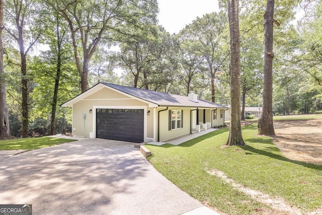 1017 Oak Ridge Dr, Byron, GA 31008 - ranch-style home with a chimney, driveway, a front yard, and a garage