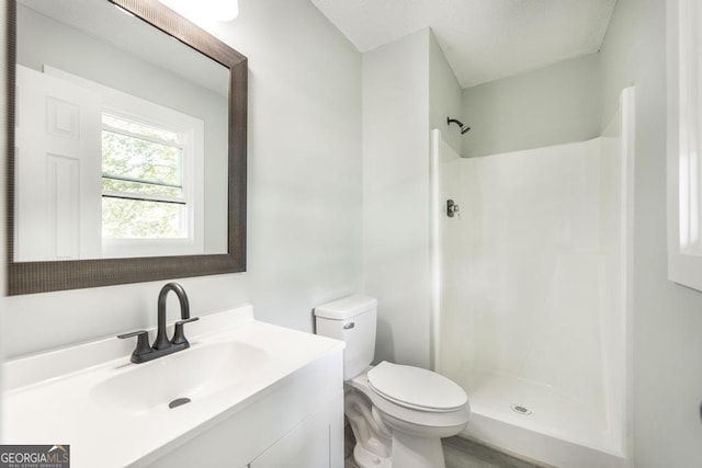 1017 Oak Ridge Dr, Byron, GA 31008 - full bathroom with vanity, toilet, and a shower