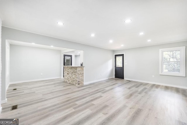 1017 Oak Ridge Dr, Byron, GA 31008 - unfurnished living room with healthy amount of natural light, recessed lighting, baseboards, and light wood finished floors