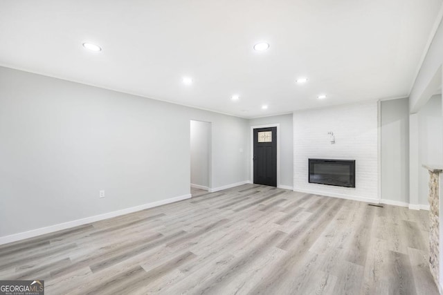 1017 Oak Ridge Dr, Byron, GA 31008 - unfurnished living room with recessed lighting, a fireplace, light wood-style flooring, and baseboards